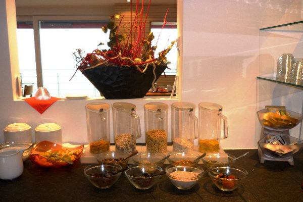 Muesli and various toppings at the breakfast buffet